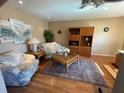 Bright living room with hardwood floors, comfy seating, and large TV at 4313 Hollow Hill Dr, Tampa, FL 33624