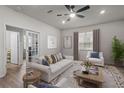 Bright living room featuring a beige sofa, armchairs, and coffee table at 4578 Emprise Way, Land O Lakes, FL 34638