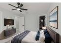 Spacious bedroom with a TV, modern decor, and ensuite bathroom at 2221 S Village Ave, Tampa, FL 33612