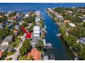 Aerial view of waterfront home with private dock and boat lift at 4923 W Melrose N Ave, Tampa, FL 33629