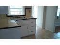 Small kitchen with white cabinets and a tile floor at 737 13Th N Ave, St Petersburg, FL 33701