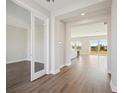 Bright entryway with hardwood floors and view to kitchen and living areas at 3437 Yellow Leaf Cir, Spring Hill, FL 34609