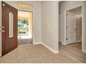 Inviting entryway featuring tile floors and an open doorway at 7806 Grasmere Dr, Land O Lakes, FL 34637