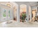 Elegant entryway with double doors and views to dining room at 8432 Dunham Station Dr, Tampa, FL 33647