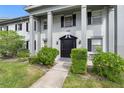 Gray building exterior with columns and landscaping at 1190 Rue Des Chateaux # 2A, South Pasadena, FL 33707