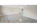 Open living room with neutral walls and tile flooring at 3600 Landale Dr, Holiday, FL 34691