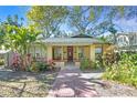 Charming bungalow with landscaped yard and brick pathway at 5700 N Suwanee Ave, Tampa, FL 33604