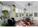 Bright sunroom features a desk, seating, and abundant natural light at 5700 N Suwanee Ave, Tampa, FL 33604