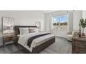 Bright bedroom with large window and comfortable seating at 1686 Fallon Pass, Zephyrhills, FL 33541
