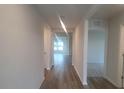 Bright hallway with wood-look flooring leading to other rooms at 11116 40Th E Ave, Palmetto, FL 34221