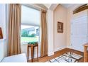 Bright entryway with hardwood floors, window seat, and white door at 2403 Richmond Greens Ct, Sun City Center, FL 33573