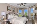 Spacious bedroom with bay window, desk area, and neutral decor at 4504 Isonzo Way, Wesley Chapel, FL 33543