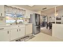 Kitchen area features stainless steel refrigerator and view of the dining area at 13084 Drysdale St, Spring Hill, FL 34609