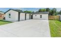 Newly built home with a large concrete driveway at 7408 W Henry Ave, Tampa, FL 33615