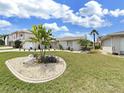 Single story home with attractive landscaping and a stone exterior at 9841 San Sebastian Way, Port Richey, FL 34668