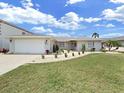 Newly renovated ranch-style house featuring a stone exterior and well-manicured lawn at 9841 San Sebastian Way, Port Richey, FL 34668