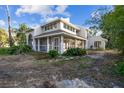 Two-story house with light gray siding, screened porch, and mature landscaping at 17307 Linda Vista Cir, Lutz, FL 33548