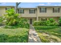 Tan two-story townhome with lush landscaping and walkway at 5313 Bayshore Blvd # 5313, Tampa, FL 33611