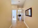 Long hallway with light walls and tile floors at 10718 Standing Stone Dr, Wimauma, FL 33598