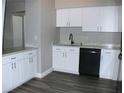 Modern kitchen with white cabinets and new appliances at 2410 W Azeele St # 212, Tampa, FL 33609