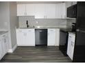 Modern kitchen with white cabinets and new appliances at 2410 W Azeele St # 212, Tampa, FL 33609