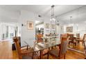 Elegant dining room with glass table and hardwood floors at 10823 Indian Hills Ct # 32, Seminole, FL 33777