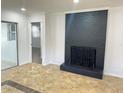 Living room with a dark brick fireplace and tile flooring at 701 S Oakwood Ave, Brandon, FL 33511
