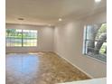 Bright living room featuring tile flooring and large windows at 701 S Oakwood Ave, Brandon, FL 33511