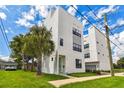 Contemporary three-story home with green door and palm trees at 310 N Oregon Ave, Tampa, FL 33606