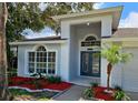 Modern front entrance with double doors and decorative glass, and landscaping at 2204 Cattleman Dr, Brandon, FL 33511