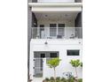 Contemporary townhome featuring a white balcony, string lights, and a private gated entry at 41 29Th N St, St Petersburg, FL 33713