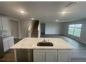 Modern kitchen island with a stainless steel dishwasher at 6303 Distant Haze Pl, Palmetto, FL 34221