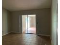 Bedroom with tile floors and sliding glass doors at 8602 Stoner Rd, Riverview, FL 33569