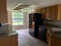 Kitchen with granite countertops and wood cabinets at 8602 Stoner Rd, Riverview, FL 33569