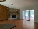 Living room with stone fireplace and sliding glass doors at 8602 Stoner Rd, Riverview, FL 33569