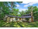 One-story home nestled among lush trees and greenery at 244 Lark Ave, Brooksville, FL 34601