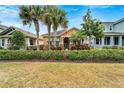 Front view of charming house with landscaping and palm trees at 320 Winterside Dr, Apollo Beach, FL 33572