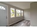 Bright entryway with wood-look floors, neutral walls, and multiple windows at 2409 S 70Th St, Tampa, FL 33619