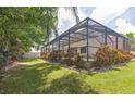 Screened-in pool and patio area with lush landscaping at 309 Dakota Hill Dr, Seffner, FL 33584