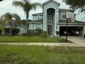 Attractive two-story home with a basketball hoop by the driveway and mature landscaping at 13034 Avalon Crest Ct, Riverview, FL 33579