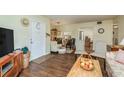 Living room with hardwood floors, showing kitchen and entryway at 3133 Lake Pine Way # D1, Tarpon Springs, FL 34688
