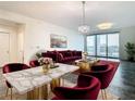 Elegant living room with marble dining table and red velvet furniture at 920 N Osceola Ave # 703, Clearwater, FL 33755