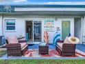 Relaxing patio with wicker furniture and tropical decor at 7809 39Th N Ave, St Petersburg, FL 33709