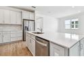 Bright kitchen featuring a large island and stainless steel dishwasher at 13806 Sunlight Meadow Dr, Riverview, FL 33578