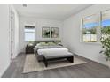 Bright bedroom with gray bedding and large windows at 13808 Sunlight Meadow Dr, Riverview, FL 33578