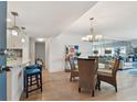 Bright dining area with glass-top table and wicker chairs, near kitchen at 1120 N Shore Ne Dr # 703, St Petersburg, FL 33701