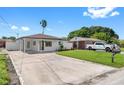 Newly renovated home with modern facade, landscaped lawn, and driveway at 2906 W Braddock St, Tampa, FL 33607