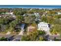 Aerial view of a vacant lot, neighboring houses and bay at 3605 S Omar Ave, Tampa, FL 33629