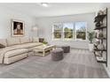 Spacious Gathering room featuring a comfy sectional sofa and large windows at 13810 Sunlight Meadow Dr, Riverview, FL 33578