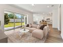 Bright living room with sliding glass doors leading to backyard at 13810 Sunlight Meadow Dr, Riverview, FL 33578